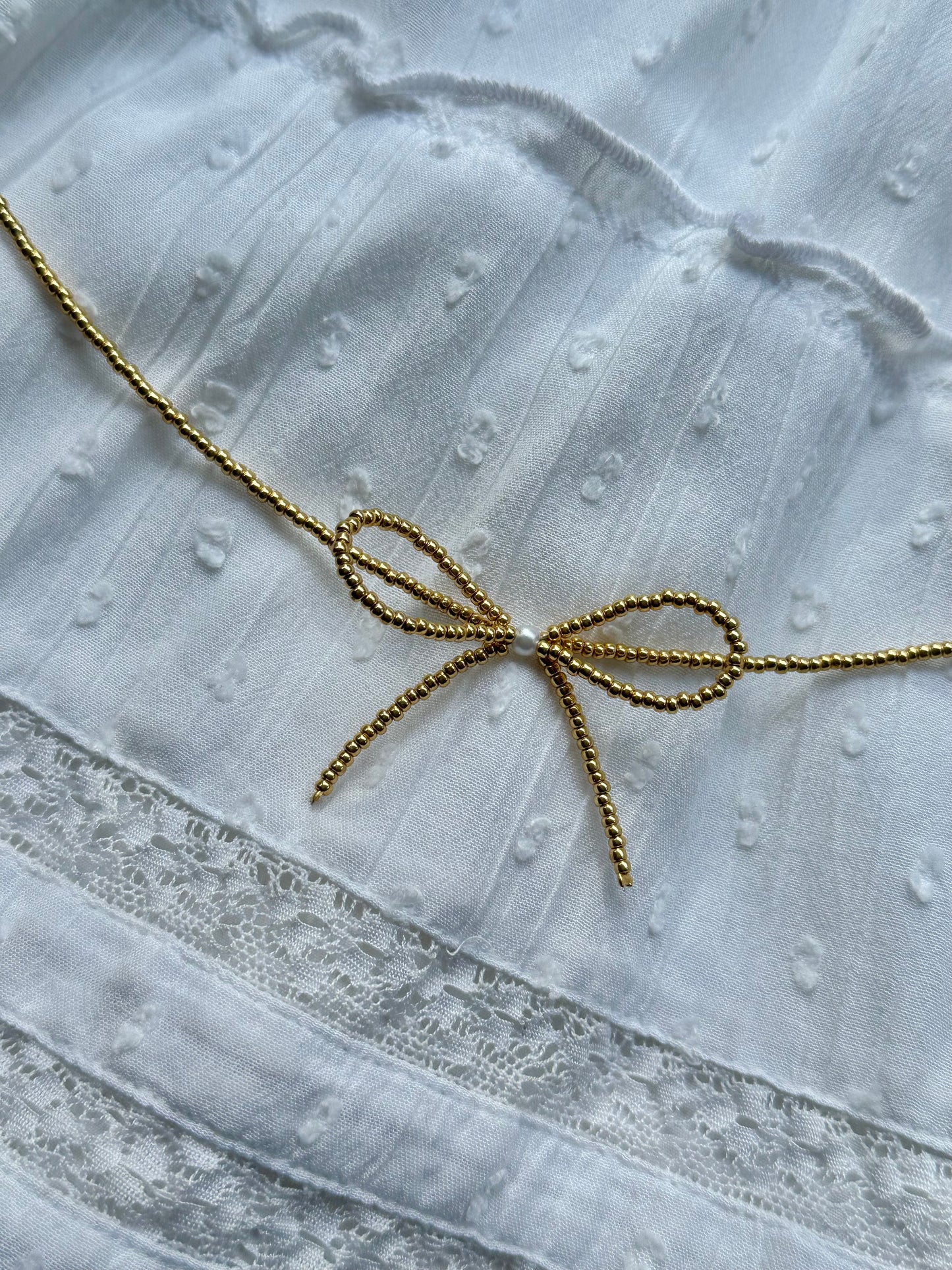 beaded gold bow necklace