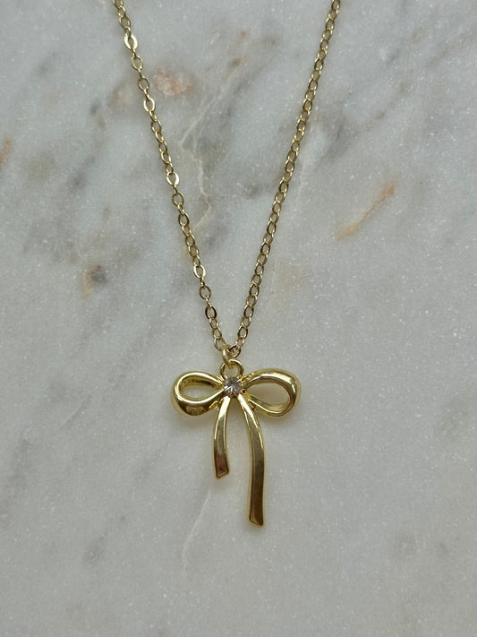 gold bow with gem necklace