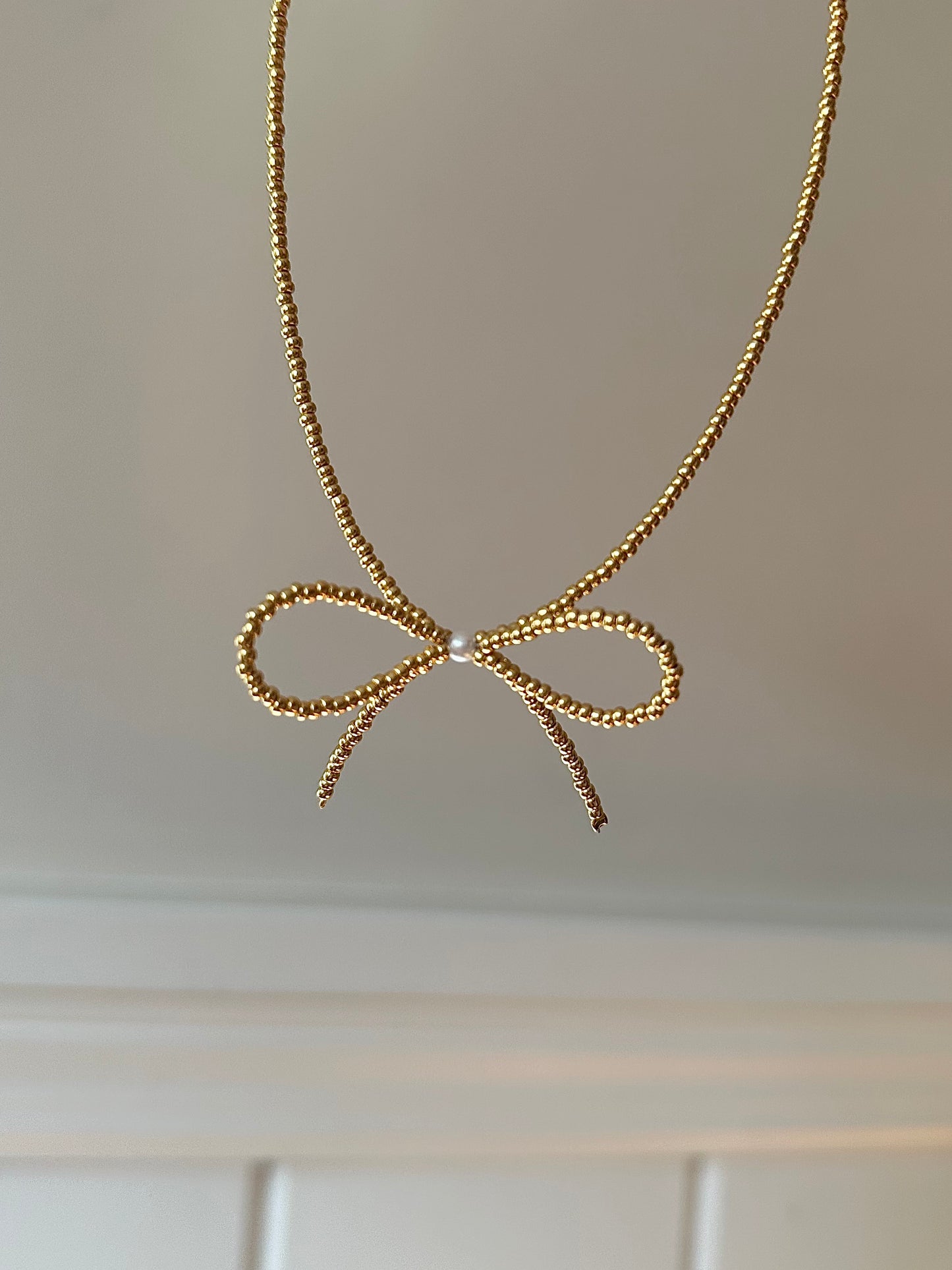 beaded gold bow necklace