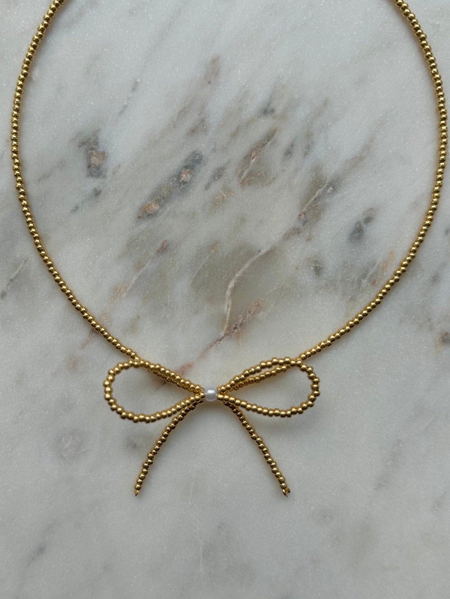 beaded gold bow necklace